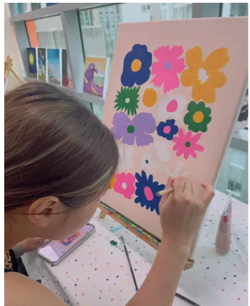 Artist working on a colourful flower composition