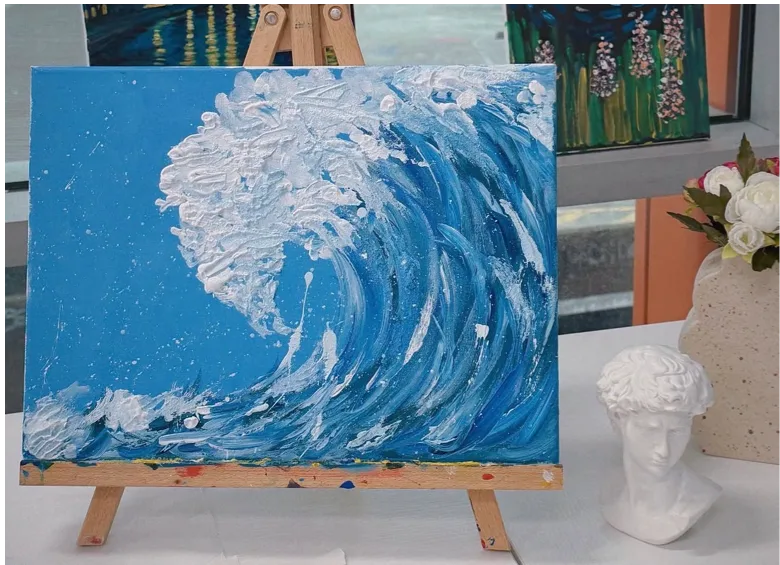 Blue wave painting on an easel