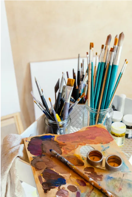 Paint brushes and an artist's palette in the Studio21 workspace